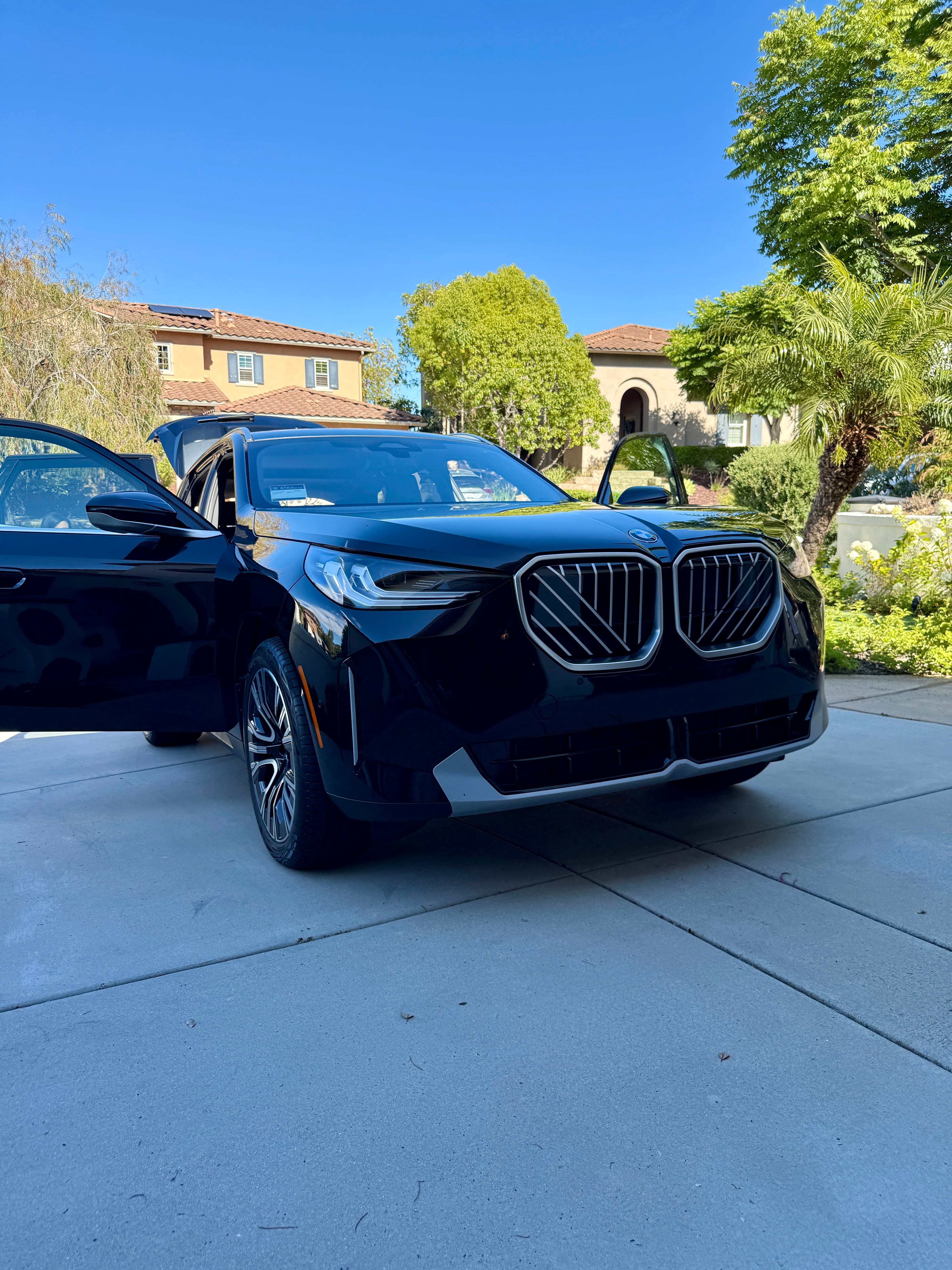 2025 black bmw x3 residential driveway